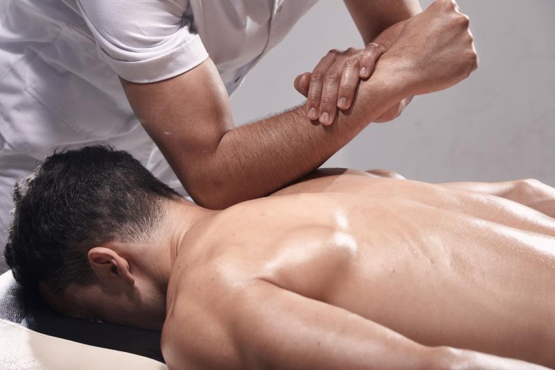 Massage therapist performing sports massage